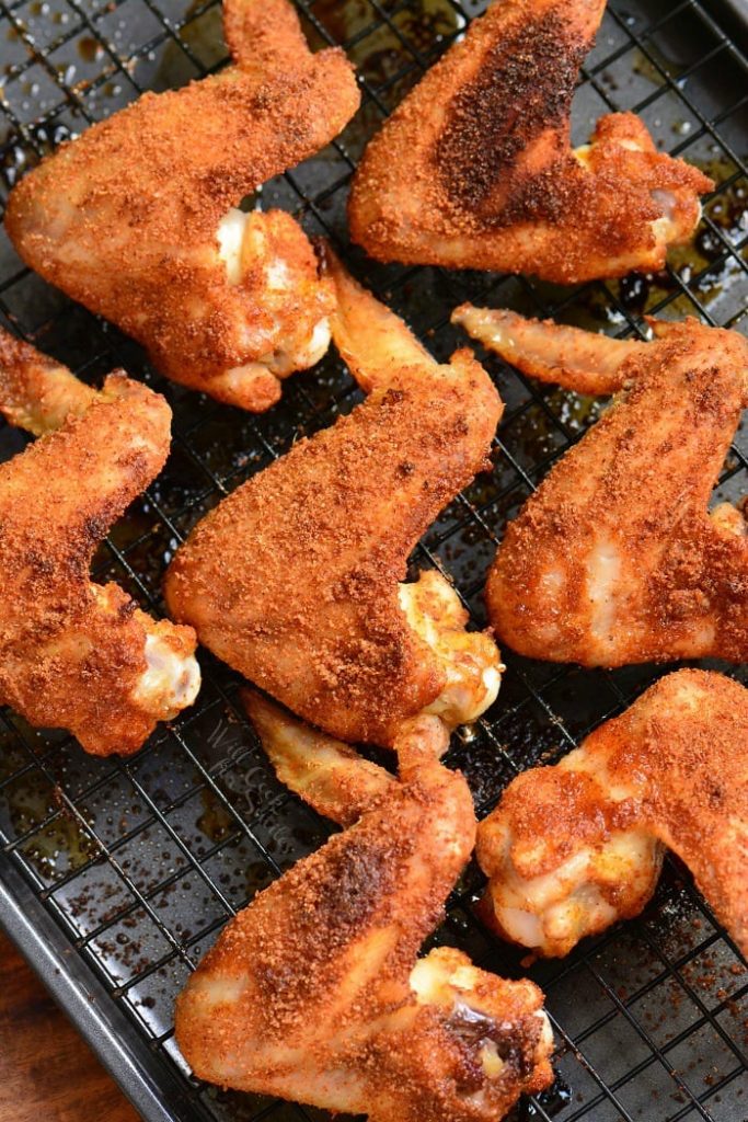 baked chicken wings in the rack inside a baking sheet.