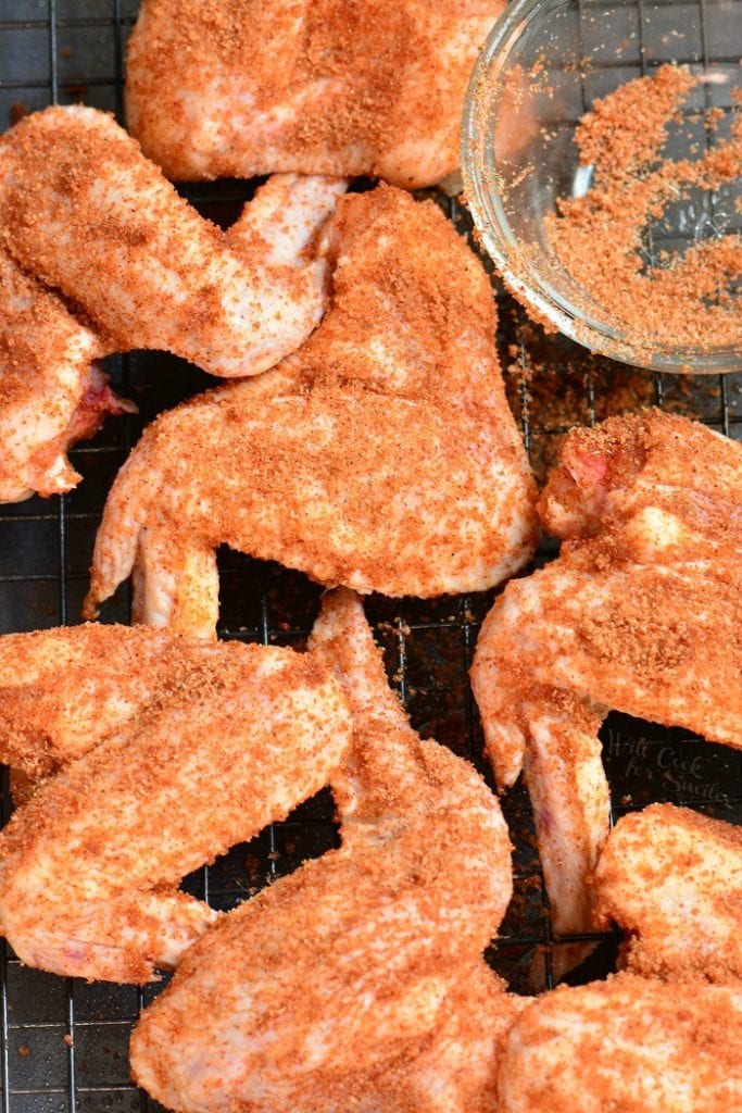 uncooked chicken wings coated in a dry rub.