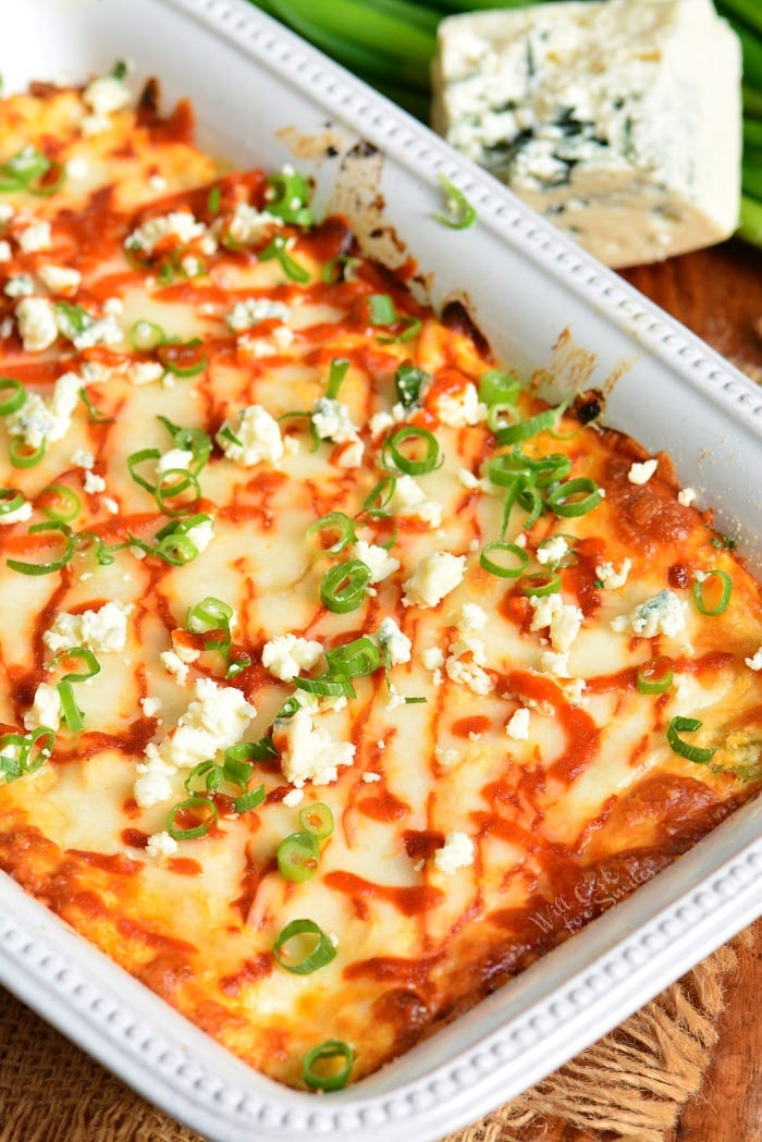 Buffalo Chicken Dip is a perfect party dip made with chicken meat cooked in buffalo wing sauce, cream cheese, Monterrey Jack cheese, and Blue cheese crumbles. #dip #chickendip #appetizer #partyfood #buffalochicken