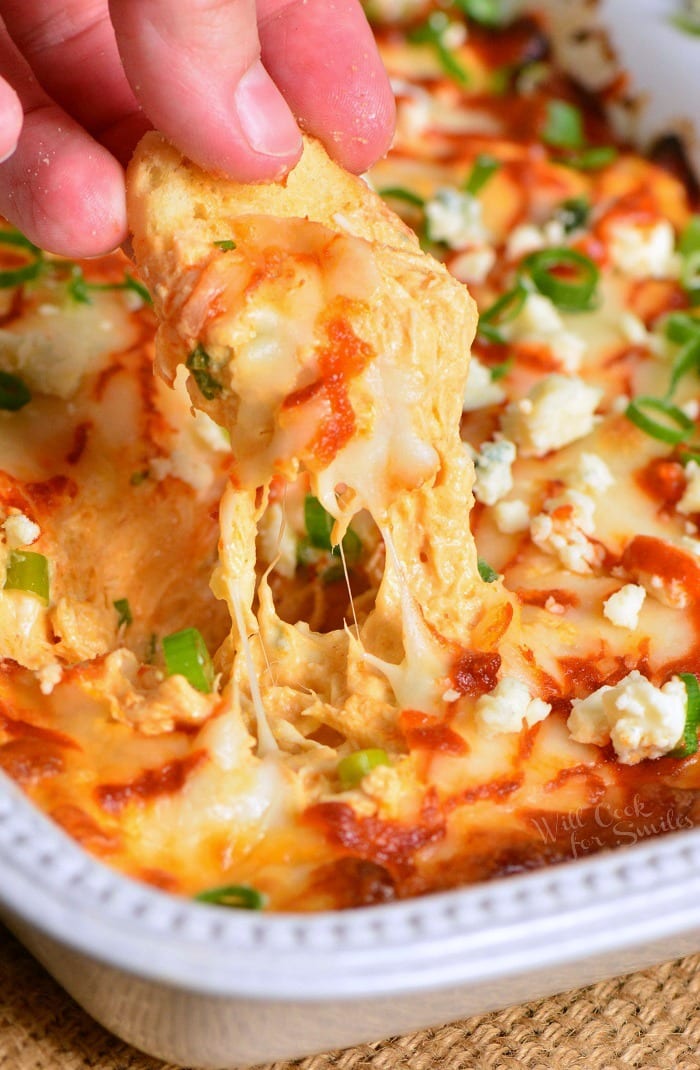 Buffalo Chicken Dip recipe for a perfect party dip made with chicken meat cooked in buffalo wing sauce, cream cheese, Monterrey Jack cheese, and Blue cheese crumbles. #dip #chickendip #appetizer #partyfood #buffalochicken