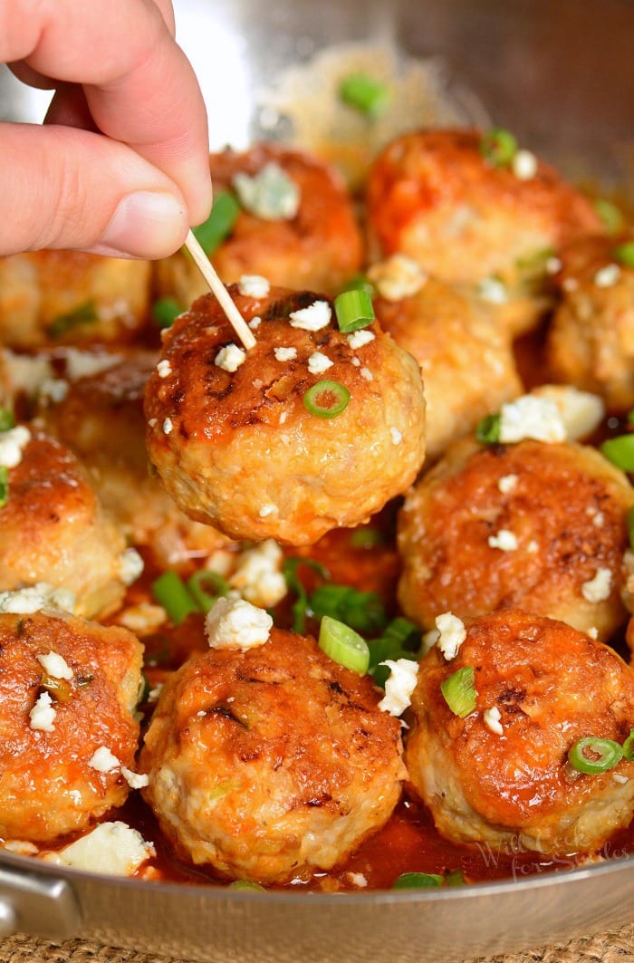 Buffalo meatballs with blue cheese with toothpick going into one