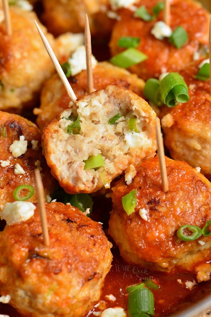 Buffalo meatballs with blue cheese with toothpicks in them 