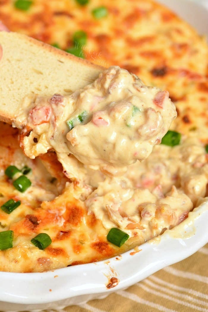 Shrimp Dip with bread dipping some out 