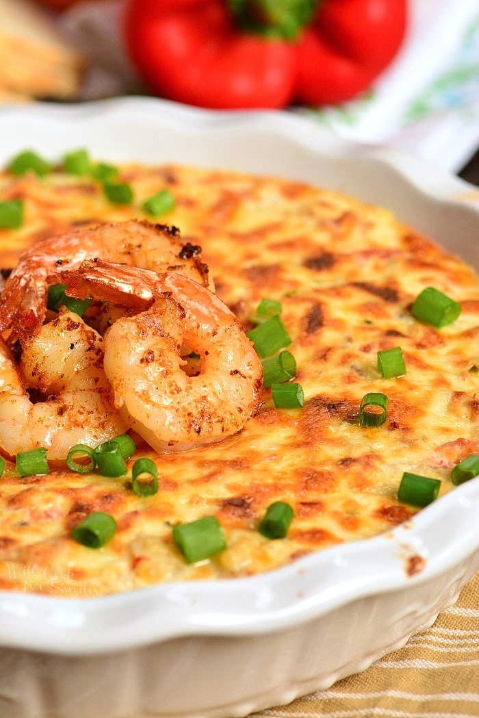 Cajun Shrimp Dip in a baking dish with shrimp on top 