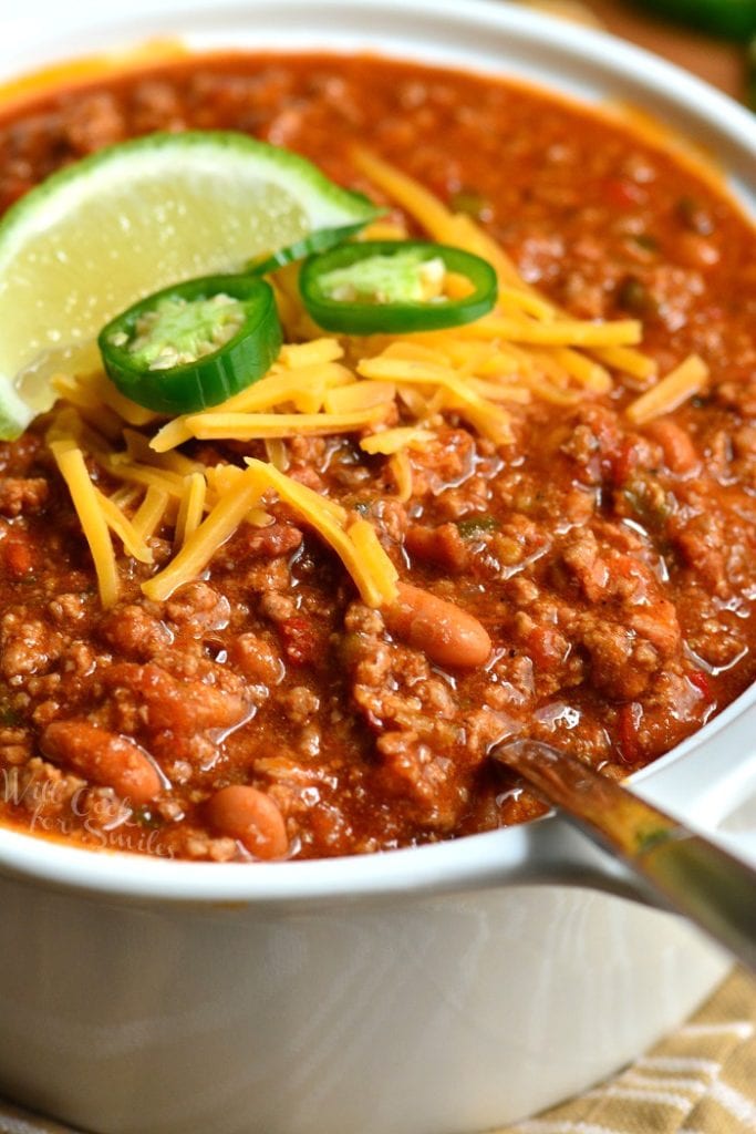 closeup of chili in a bowl with cheese and jalapenos. 