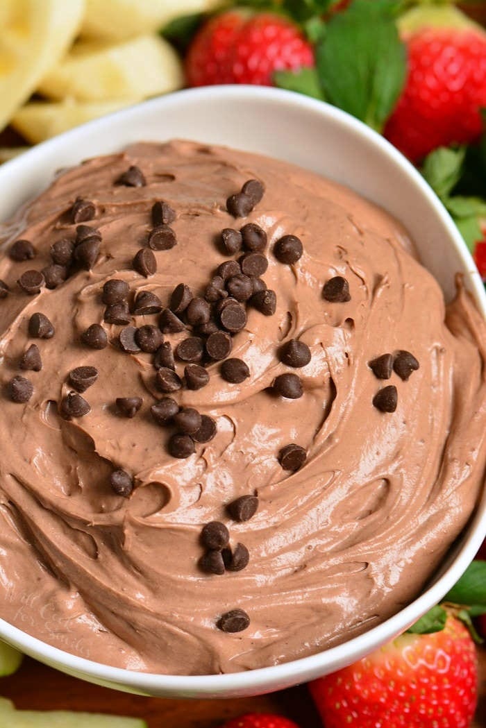 Above shot of chocolate cake fruit dip in a white bowl.