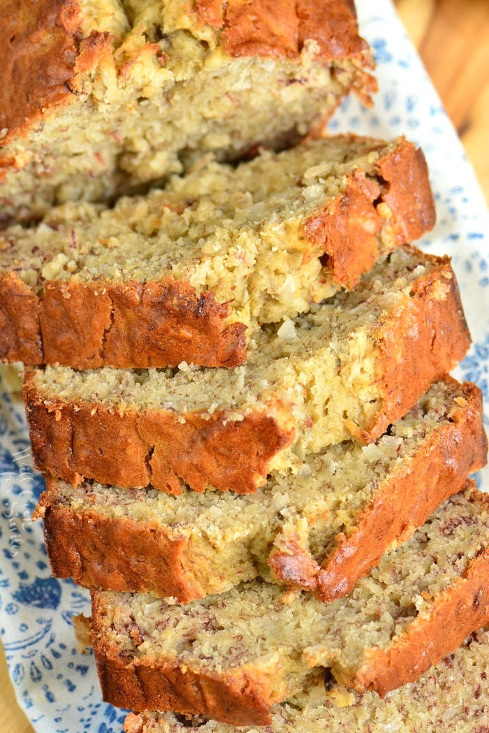 Coconut Banana Bread sliced on a platter on a cutting board 