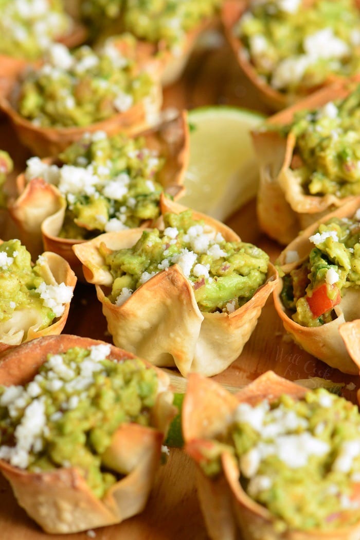 Guacamole Cups on a wood cutting board.