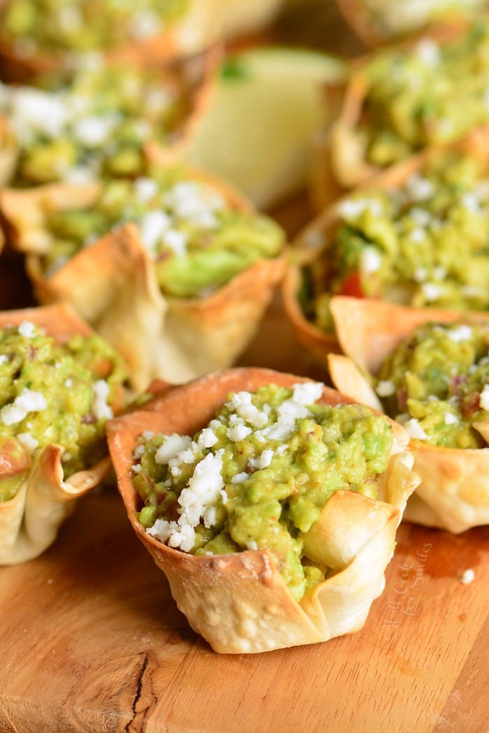 Close up of Guacamole Cups on a wood cutting board.