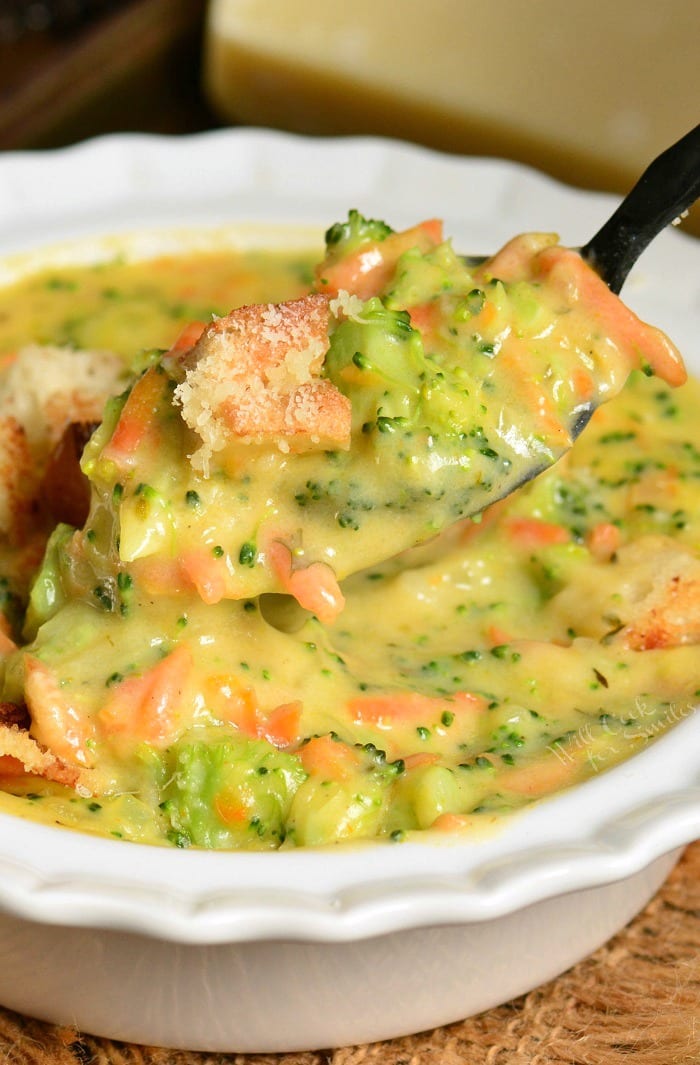 Easy Broccoli Cheese Soup in a bowl with a spoon scooping some out 