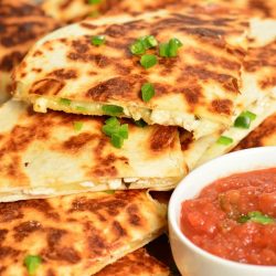 Jalapeno Popper Chicken Quesadilla on a wood cutting board.