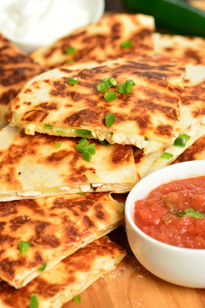 Jalapeno Popper Chicken Quesadilla on a wood cutting board.