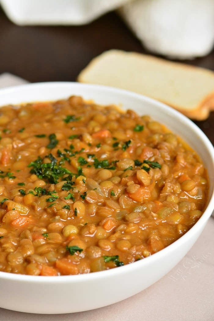 Lentil Soup in a bowl on a table with a slice of bread 