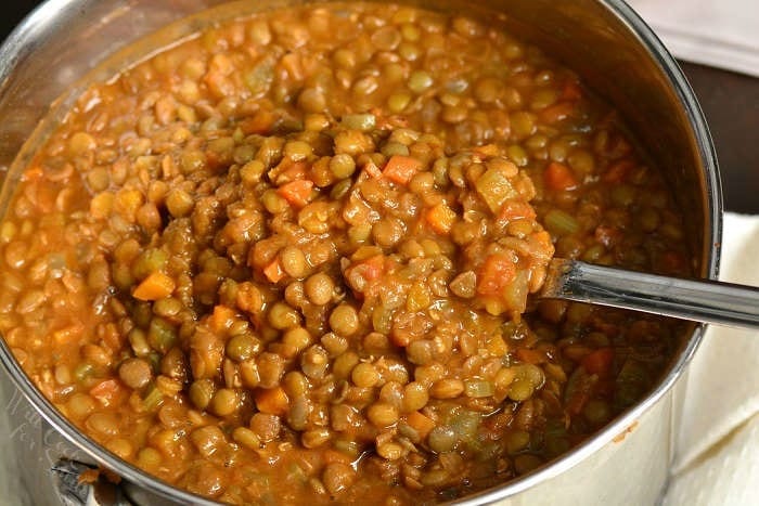 Lentil Soup in a pot with a metal spoon