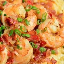 Shrimp and grits close up photo with bacon and green onions.
