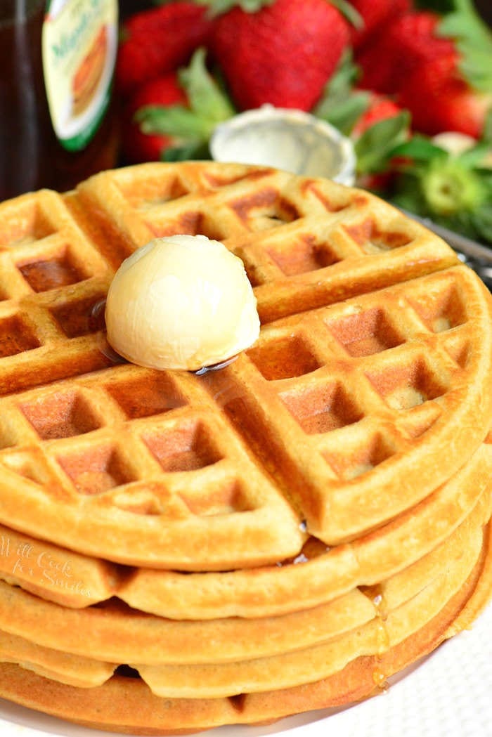 Buttermilk Waffles stacked on a plate with butter on top 