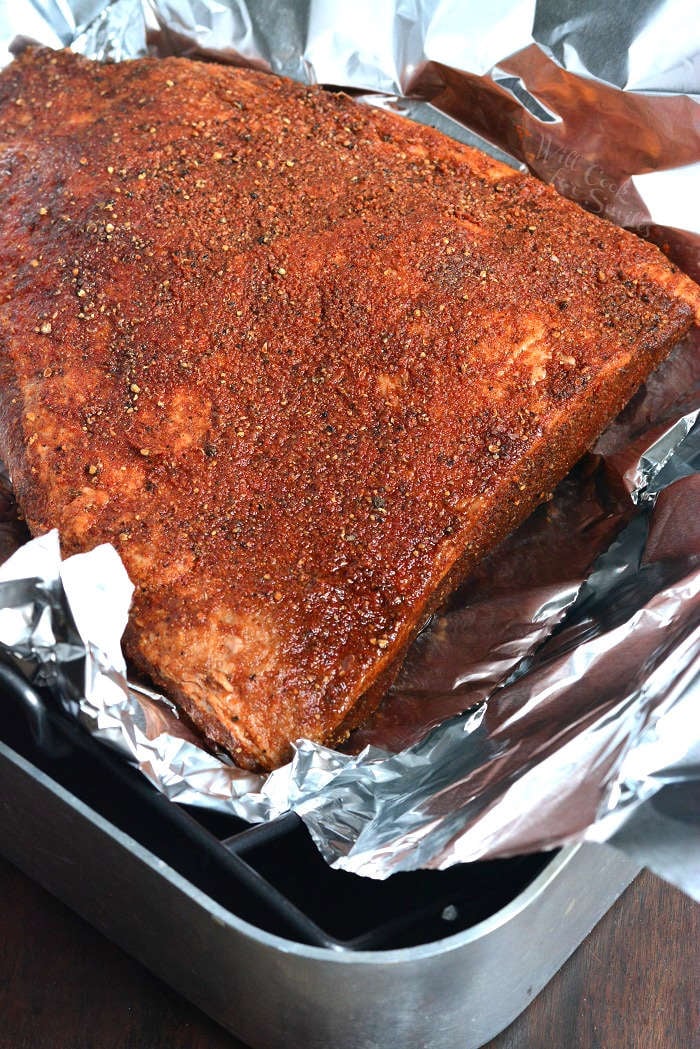 Cooking beef brisket in the oven in a roasting pan with tin foil