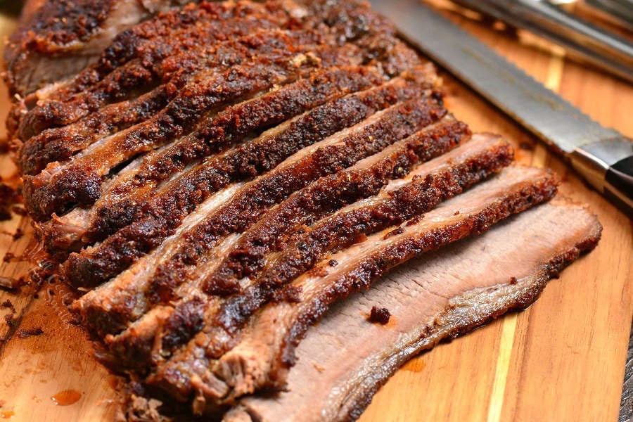 Beef Brisket sliced up on cutting board with knife 