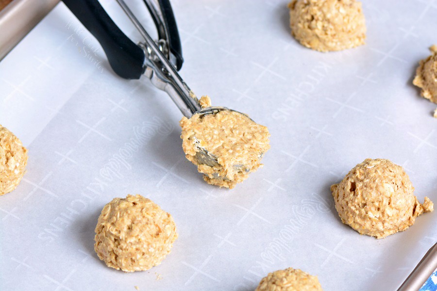 Easy Oatmeal Cookies being scoped onto parchment paper 