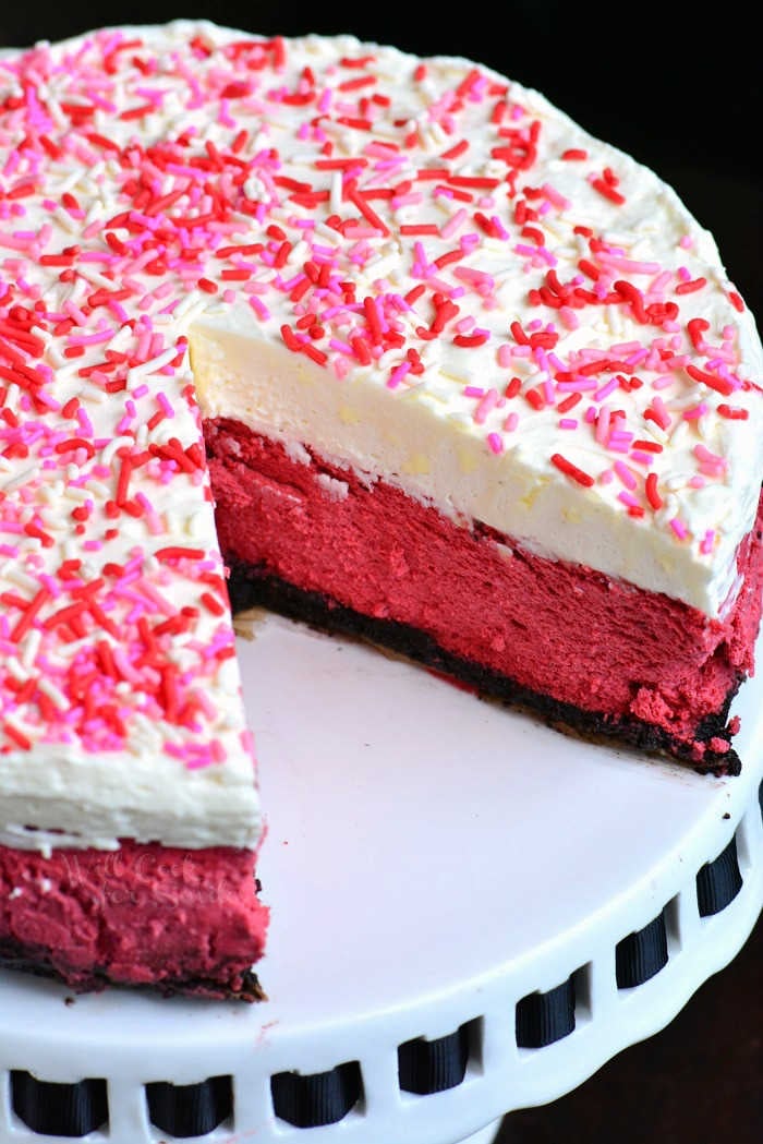Red Velvet Cheesecake. This luscious cheesecake is inspired by a traditional red velvet cake and made with buttermilk, vinegar, cocoa powder, and topped with cream cheese frosting. #cheesecake #redvelvet #dessert #frosting 