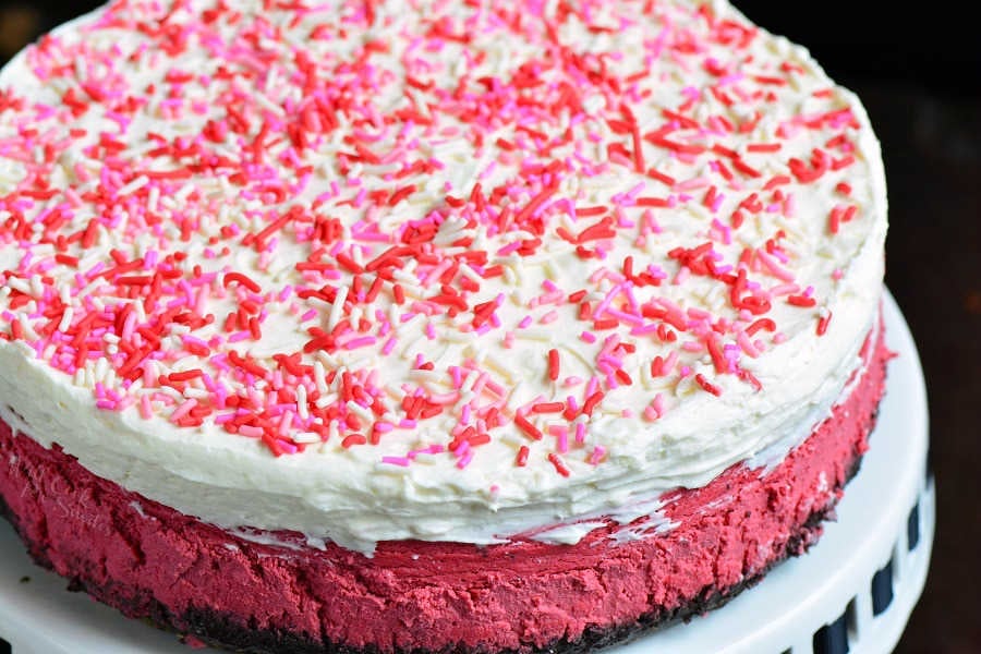 Red Velvet Cheesecake. This luscious cheesecake is inspired by a traditional red velvet cake and made with buttermilk, vinegar, cocoa powder, and topped with cream cheese frosting. #cheesecake #redvelvet #dessert #frosting 