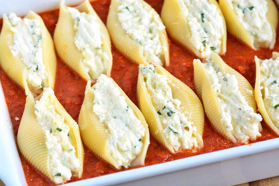 Classic Stuffed Shells made with flavorful three cheese ricotta filling and homemade marinara sauce. This stuffed shells recipe is extra cheesy and made with fresh herbs and garlic flavors. #pasta #stuffedshells #meatless #ricotta
