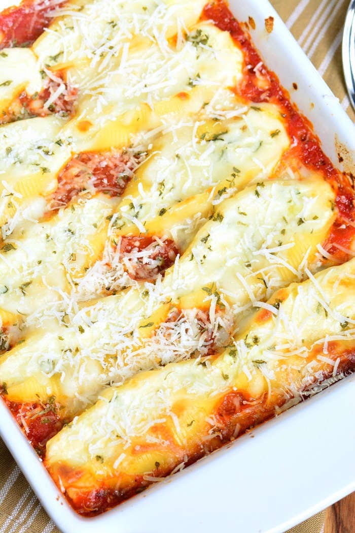 Stuffed Shells made with flavorful three cheese ricotta filling and homemade marinara sauce. This stuffed shells recipe is extra cheesy and made with fresh herbs and garlic flavors. #pasta #stuffedshells #meatless #ricotta