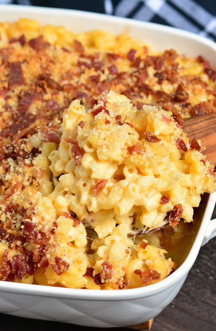 Baked Mac and Cheese in a casserole dish with a wooden spoon 