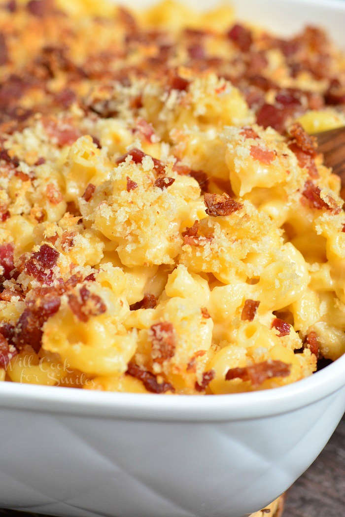 Baked Mac and Cheese in a casserole dish with a wooden spoon 