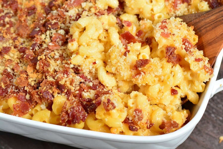 Baked Mac and Cheese in a casserole dish with a wooden spoon 