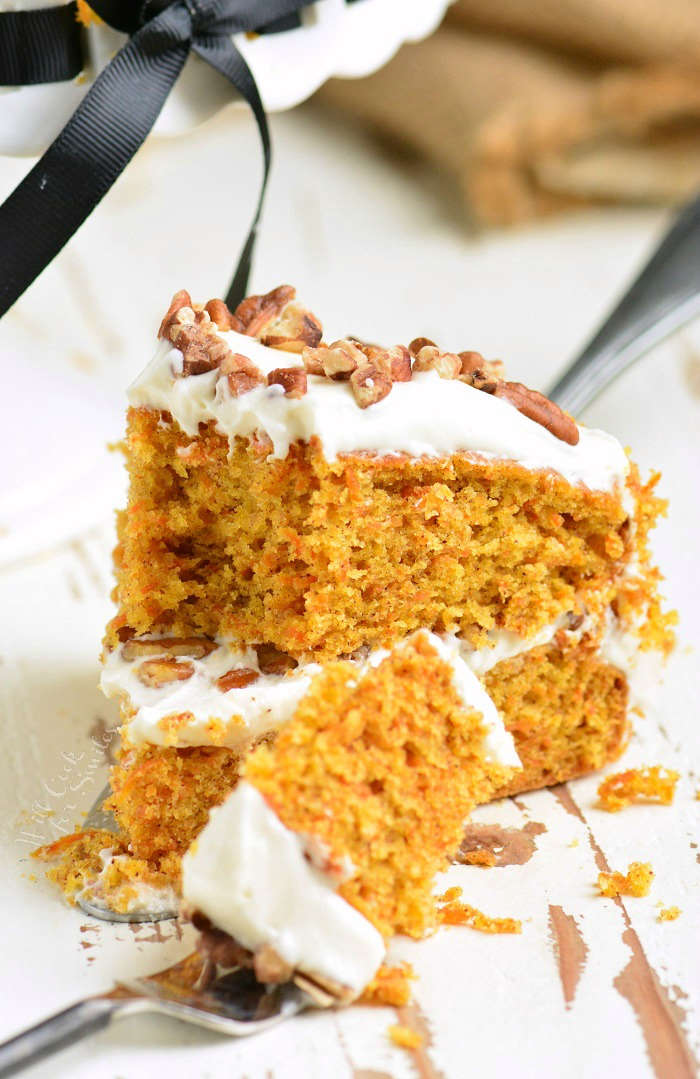 Carrot Cake recipe on a wood table with a piece on a fork 