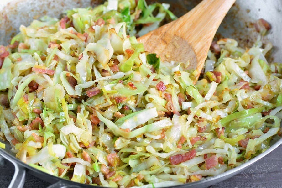 Colcannon ingredients in a pan with a wooden spoon 
