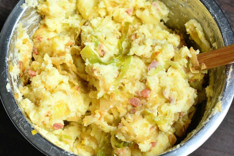 mixing fried cabbage with mashed potatoes. 