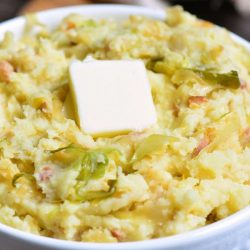 closeup of colcannon in a bowl with butter.