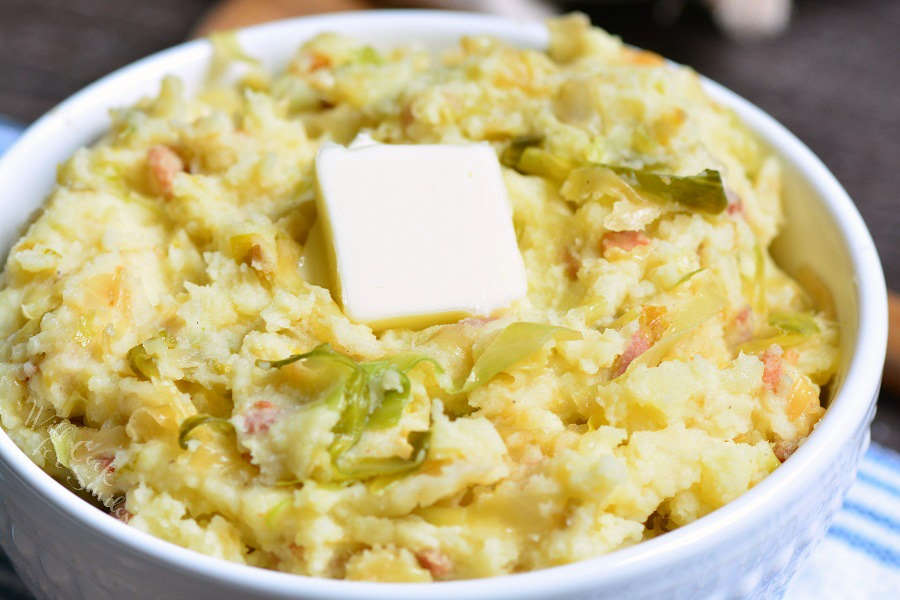 closeup of colcannon in a bowl with butter.