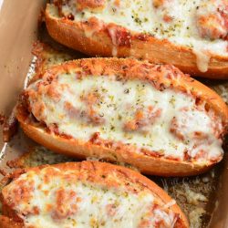 top view of three meatball subs in baking dish