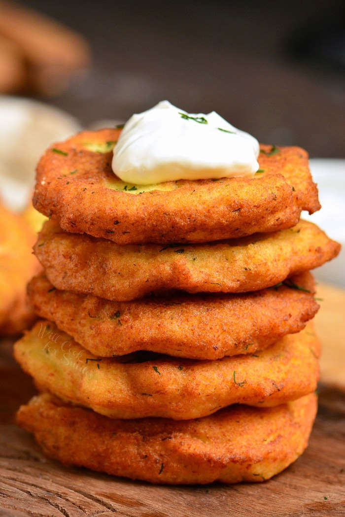 stack of potato pancakes on a wood cutting board.