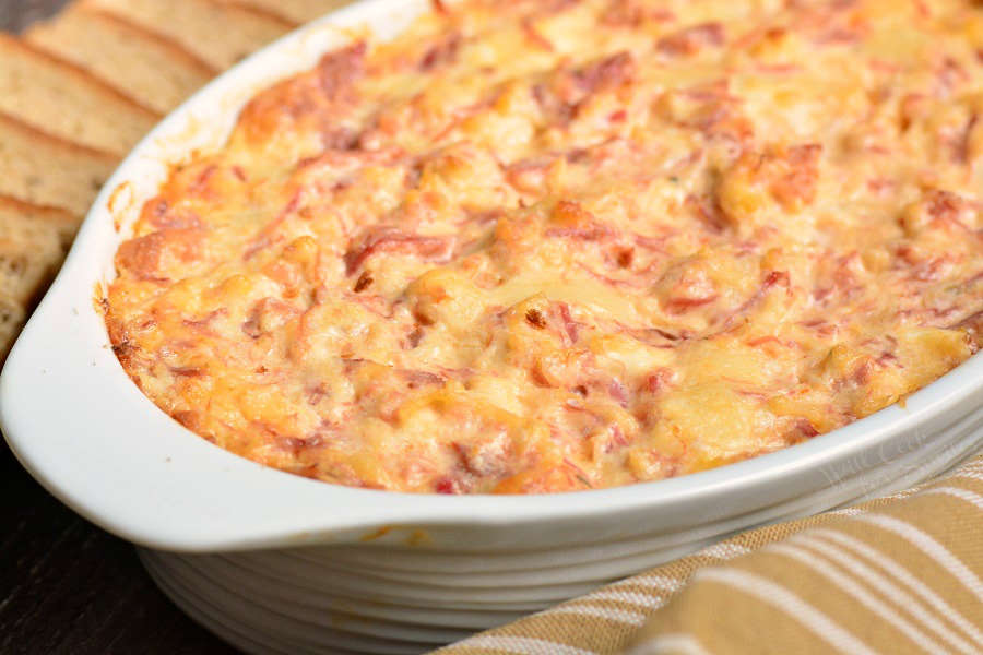 Reuben dip in casserole dish with yellow and white towel 