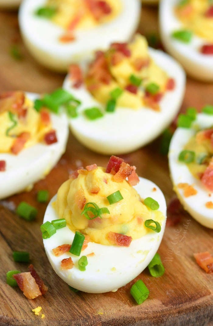 Bacon Deviled Eggs is a classic recipe taken to a whole new level. Hard boiled eggs are filled with a mixture of egg yolks, mayo, and mustard, bacon and chives.