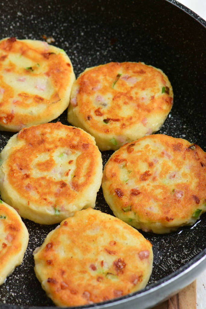 several potato cakes cooked in a pan side by side.