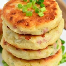 top view of stacked mashed potato cakes on white plate.