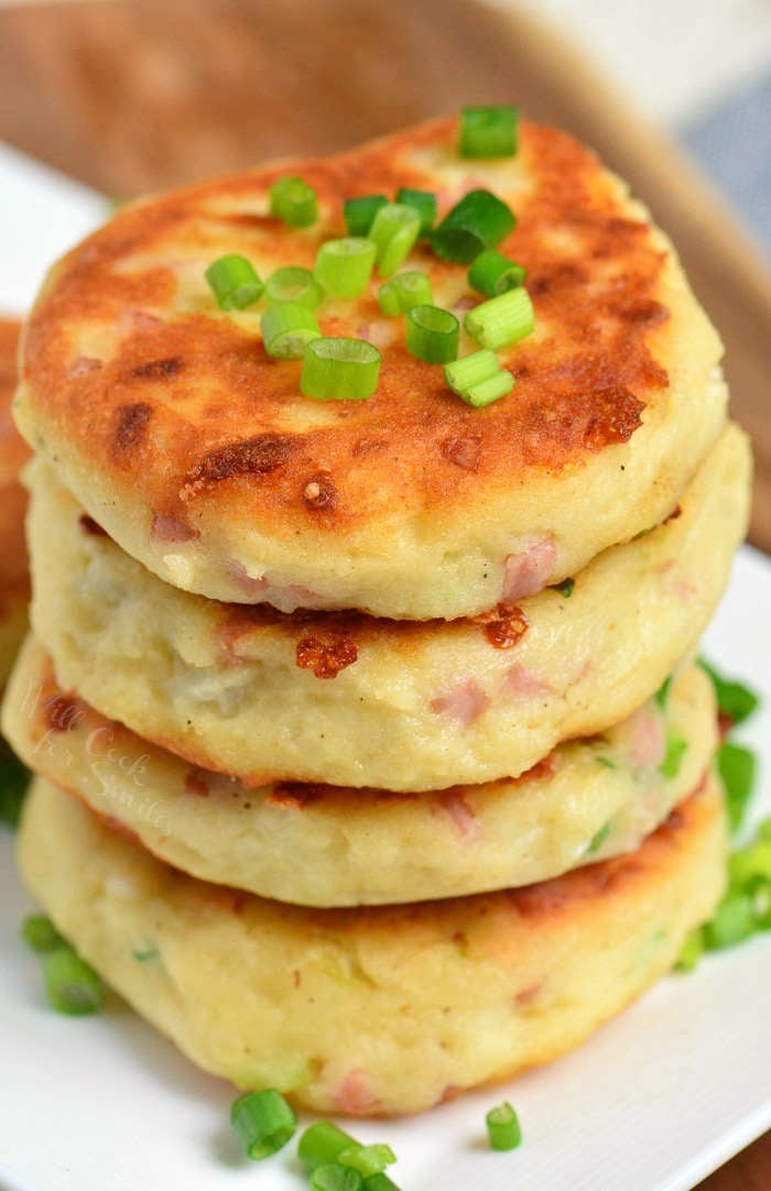 top view of stacked mashed potato cakes on white plate.