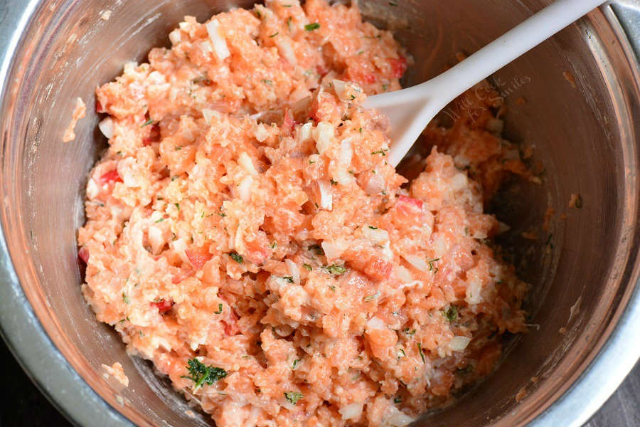 Mixing all ingredients in a metal mixing bowl with a big spoon