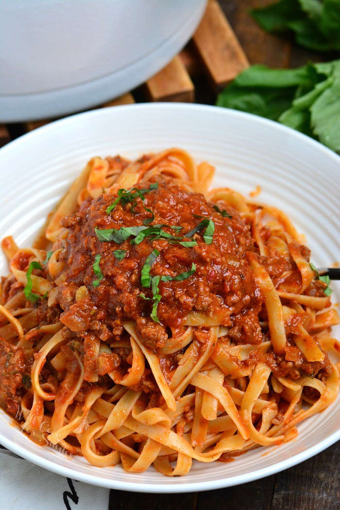 Rich Bolognese Sauce over pasta in a bowl 