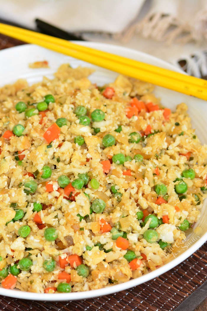 Easy Cauliflower Fried Rice in a bowl with chop sticks 