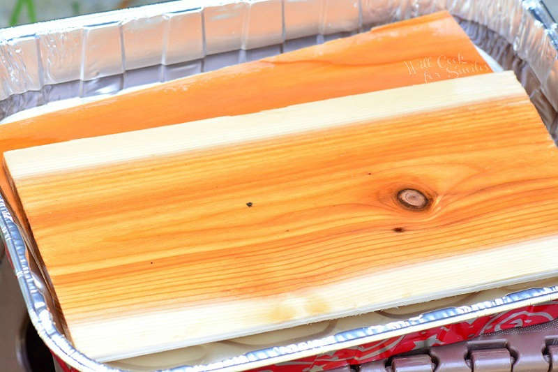 soaking cedar planks in a metal pan 