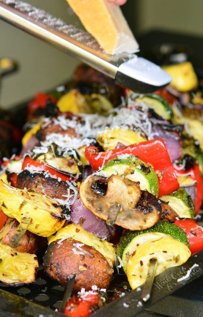 grating cheese over Grilled Vegetables with Italian flavors