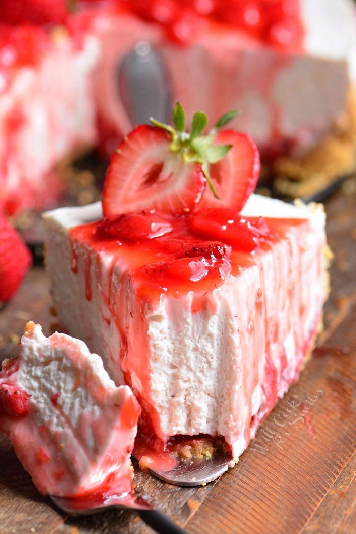 a slice of no bake strawberry cheesecake with a piece taken out with a fork.