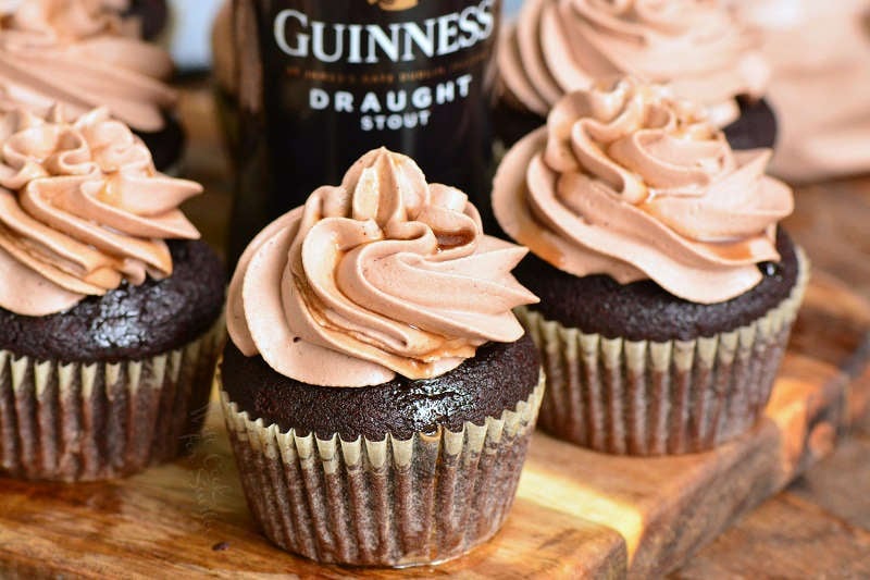 chocolate stout cupcakes on wood cutting board with bottle of stout beer 