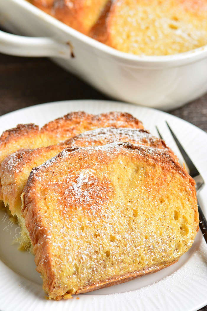 overnight french toast on plate with a fork on a wood table